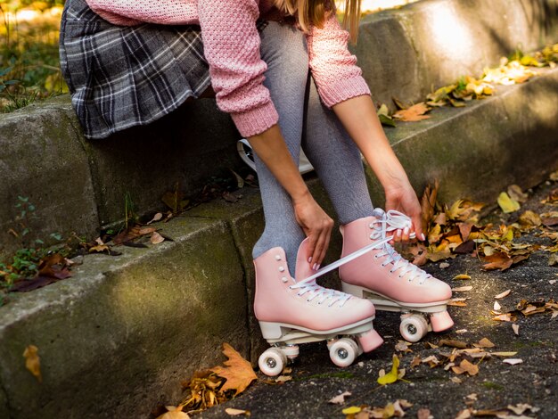 Side view of woman in roller skates and leaves