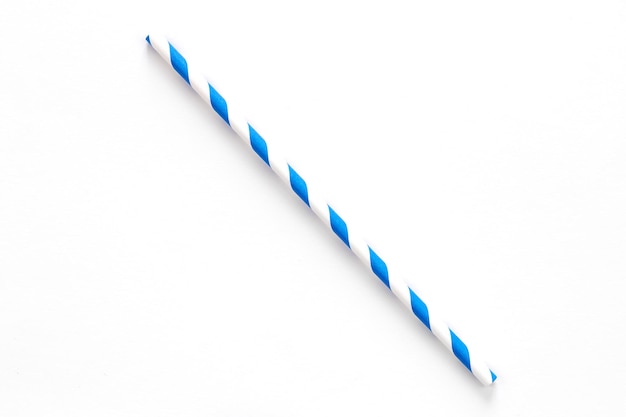 Free photo a single blue drinking straw with red and white stripes on white background