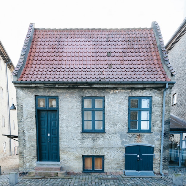 Free photo small brick house with tiled roof