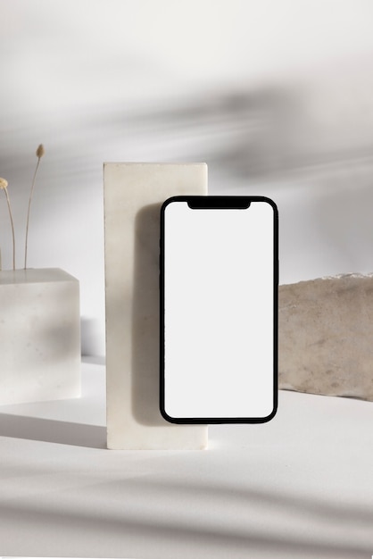 Free photo smartphone and minimal rocks arrangement