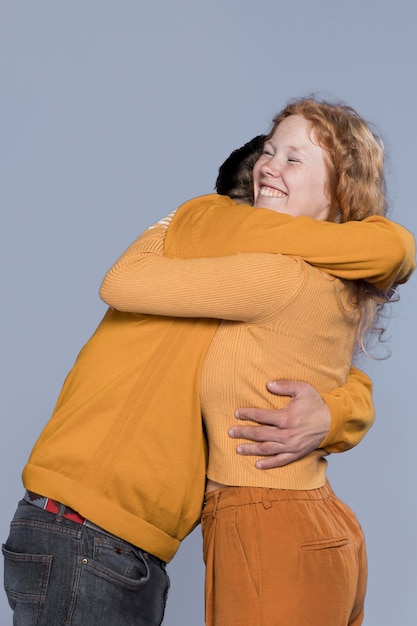 Free photo smiley woman and man hugging