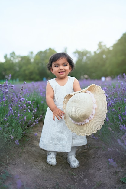 Free photo smiling baby girl posing in lavender meadow