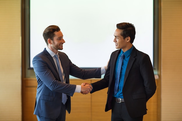 Free Photo smiling business leader greeting partner