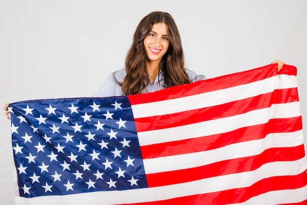 Free photo smiling woman with huge usa flag