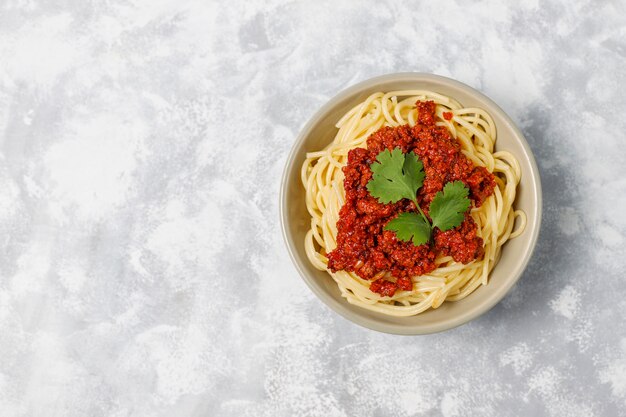 Spaghetti bolognese on grey concrete 