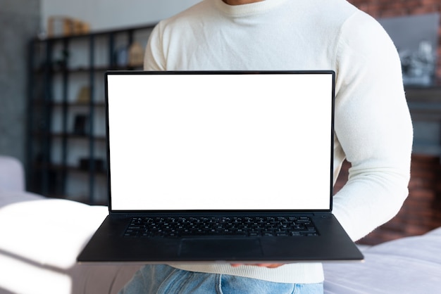 Standing man holding laptop mock-up