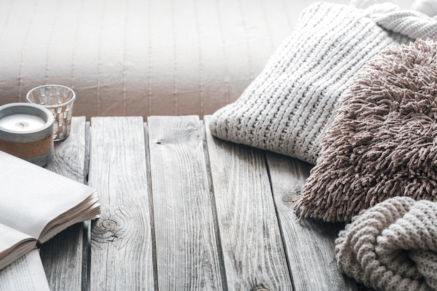 Free photo still life from home interior on a wooden background with a candle