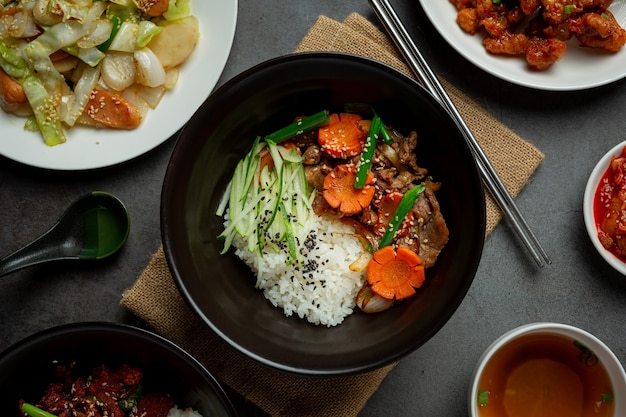 Free Photo stir fried pork with korean sauce on dark background