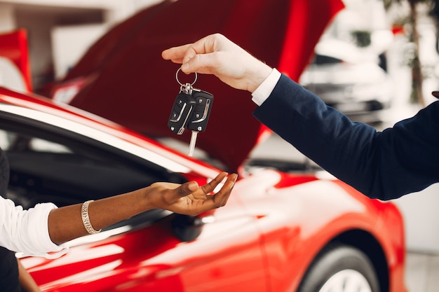 Free photo stylish black woman in a car salon