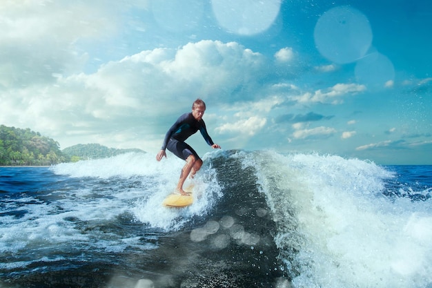 Free photo surfer on blue ocean wave getting barreled