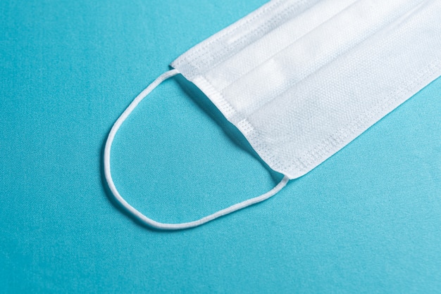 Free photo surgical mask over minimalist blue background