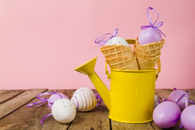 Table with watering can and easter eggs