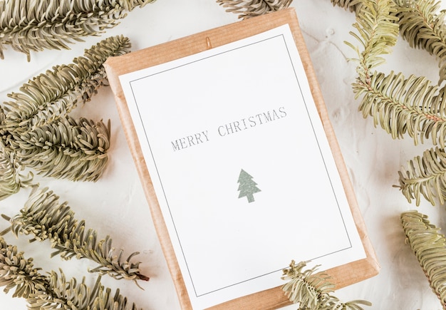 Free Photo tablet with paper between coniferous branches 