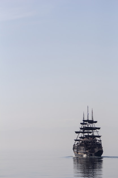 Free photo tall ship sailing on the calm water