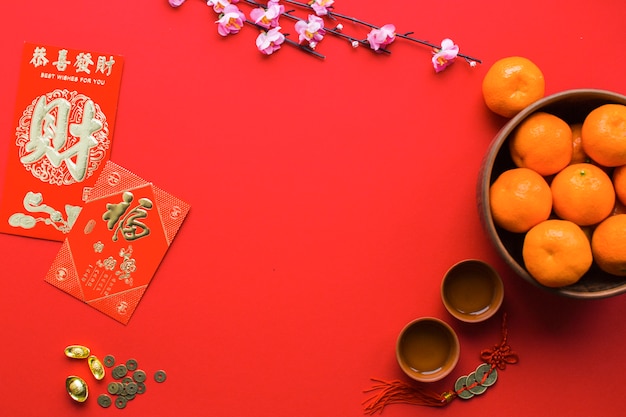 Free Photo tangerines and tea cups on red