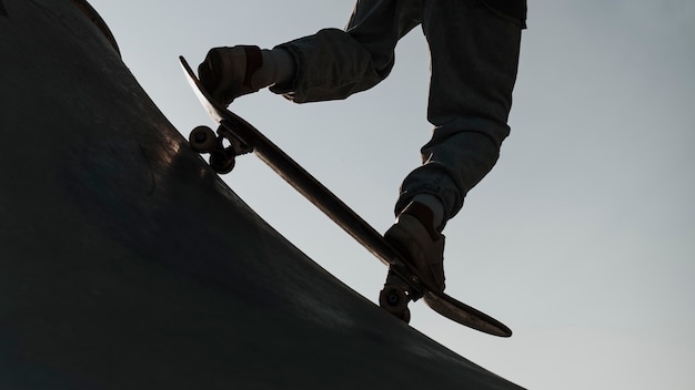 Teenager having fun with skateboard at the park silhouette