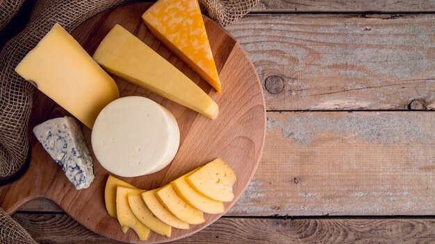 Top view assortment of delicious cheese on the table