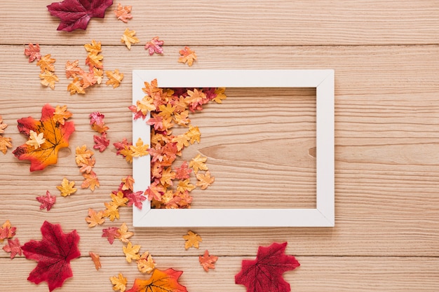 Free Photo top view autumn leaves with a frame