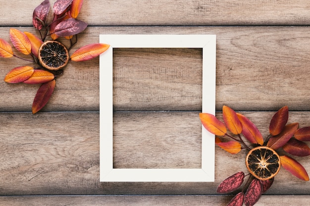 Free Photo top view autumn leaves with white frame