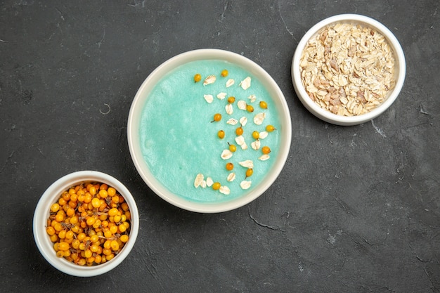 Free Photo top view blue iced dessert with raw muesli on the dark table cream ice color 