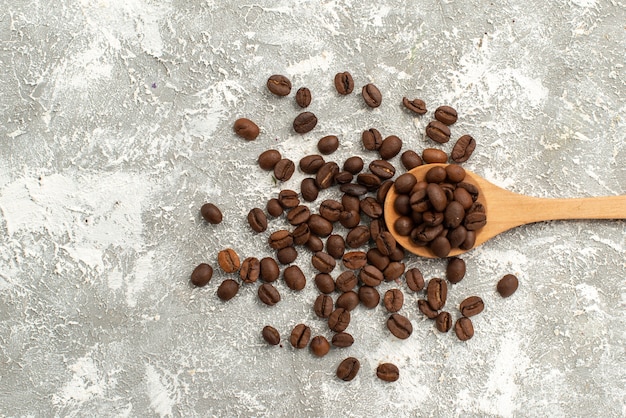 Free photo top view brown coffee seeds fresh on white background coffee seed granule