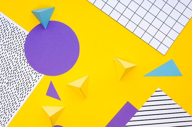 Free photo top view of colourful paper pyramids and cut-outs