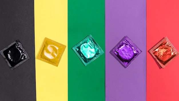 Free photo top view condoms on same colour background