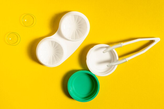 Top view of contact lenses case and tweezers