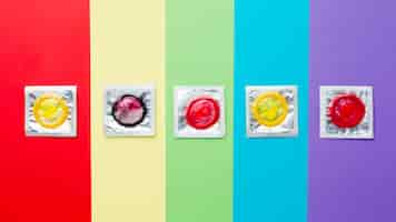 Free photo top view contraception method composition on rainbow background