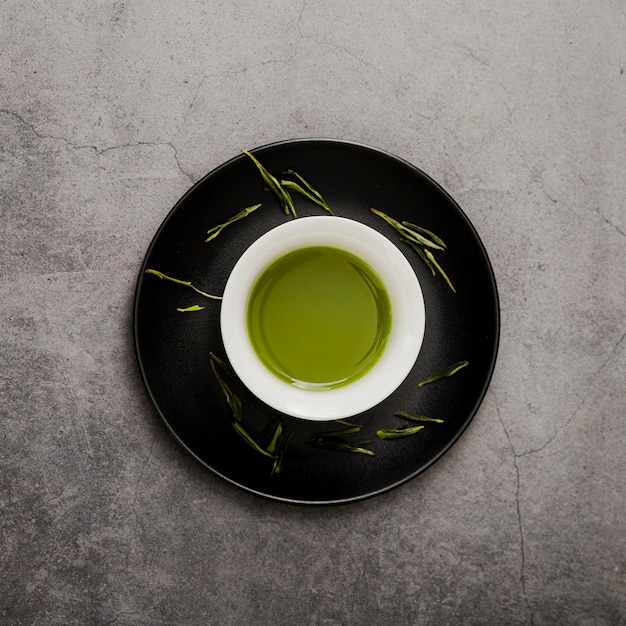 Free photo top view of cup of matcha tea on plate