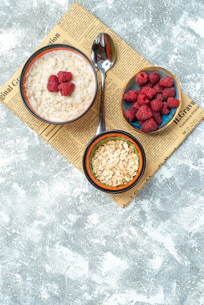 Free Photo top view delicious porridge with raspberries on light background