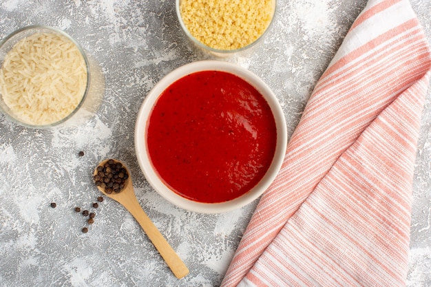 Free photo top view delicious tomato sauce inside white plate on grey desk soup meal dinner vegetable food