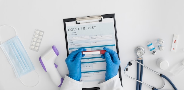 Free photo top view doctor checking covid test