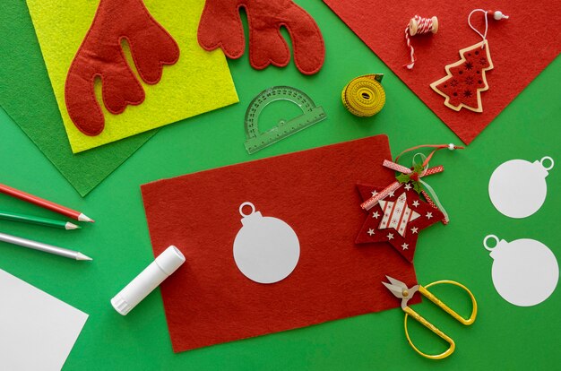 Top view of essentials for crafting christmas gift with paper and tape measurer