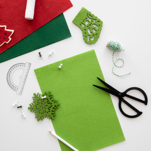 Top view of essentials for crafting christmas gift with scissors and paper