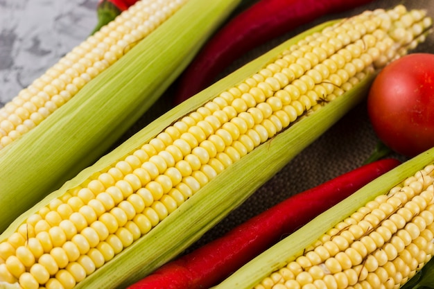 Free photo top view fresh corn and tomatoes