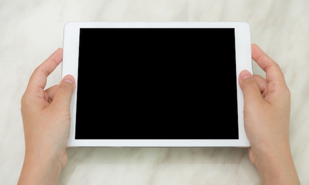 Free photo top view of hands showing a tablet