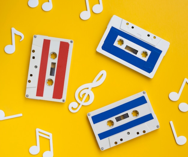 Free photo top view multicolored cassette tapes with decorative musical notes around