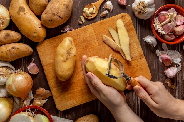 Free photo top view of person peeling potatoes