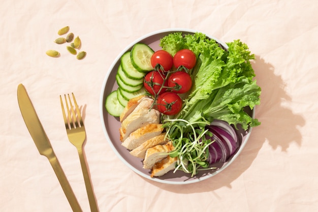 Free Photo top view  of plate with keto diet food and golden fork and knife