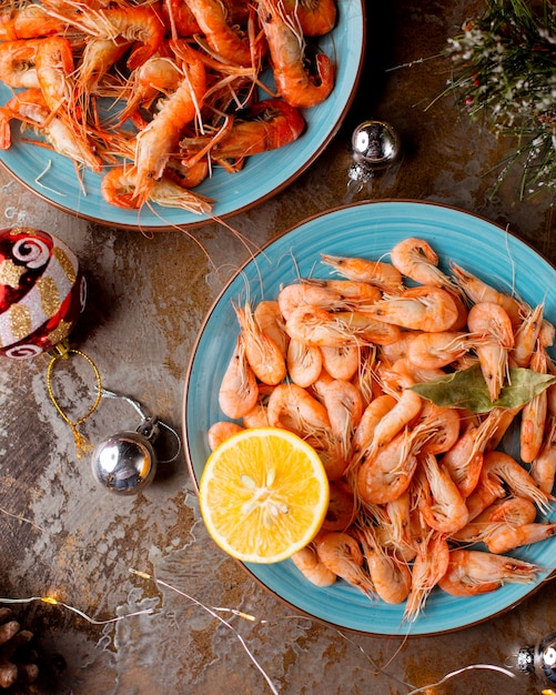 Free photo top view of prawns plates served with lemons