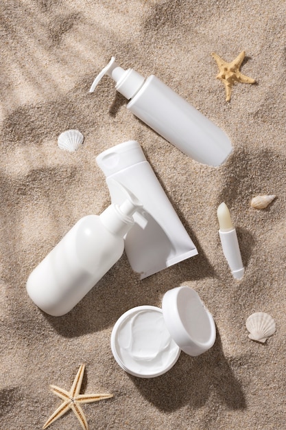 Free photo top view skincare product on the beach