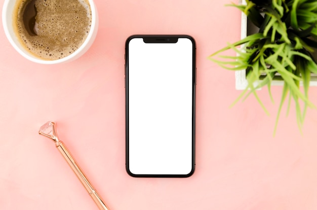 Free photo top view smartphone template over workspace