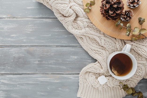 Top view tea mugand pine cones with pullover