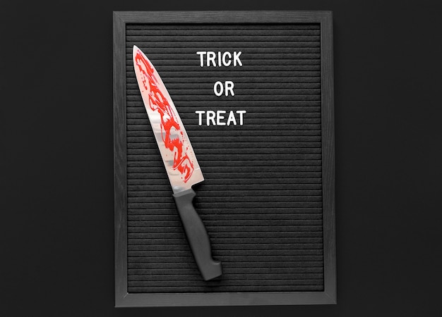 Free photo top view trick or treat with knife