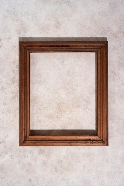 Free Photo top view wooden frame on textured background