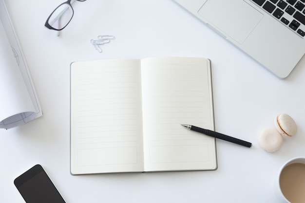 Free Photo top view of a working desk with notebook and whatman