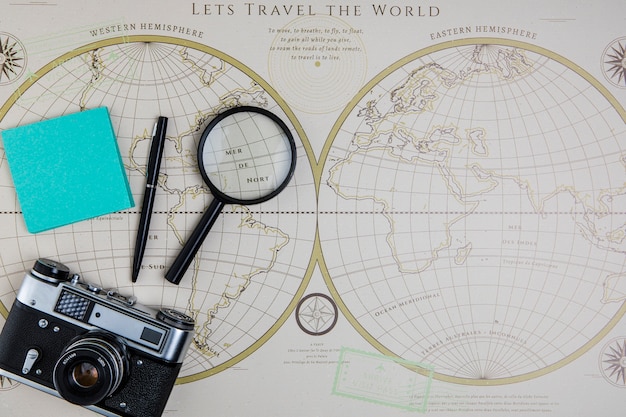 Free photo top view world map and traveling tools