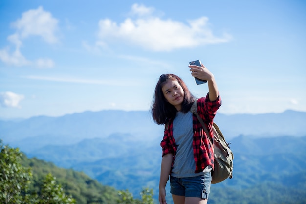 Foto gratuita viaggiatori, giovani donne, guardano le meravigliose montagne e foreste, idee di viaggio per la voglia di viaggiare,