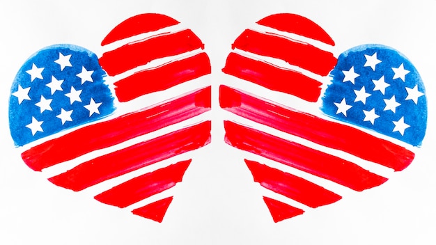 Free photo two usa flag painted heart shapes on white background